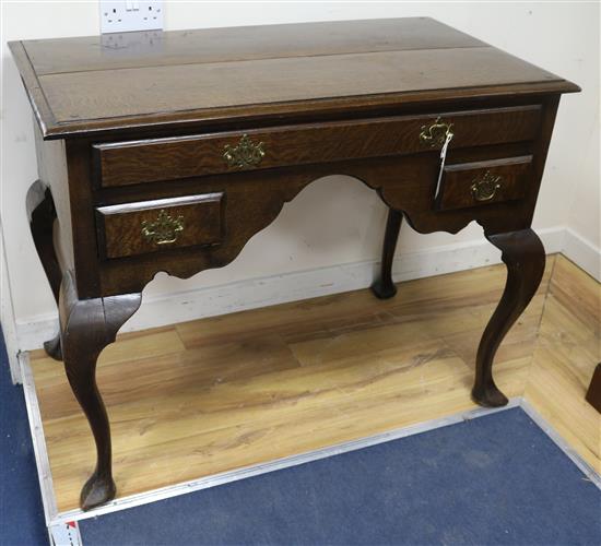 An early 18th century style oak side table W.106cm